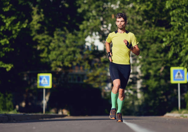 istock A sporty man runs through the streets 965423992