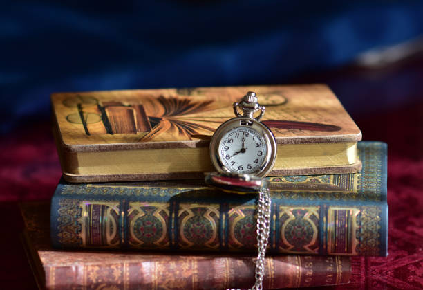 istock Old pocket watch and books 965424564