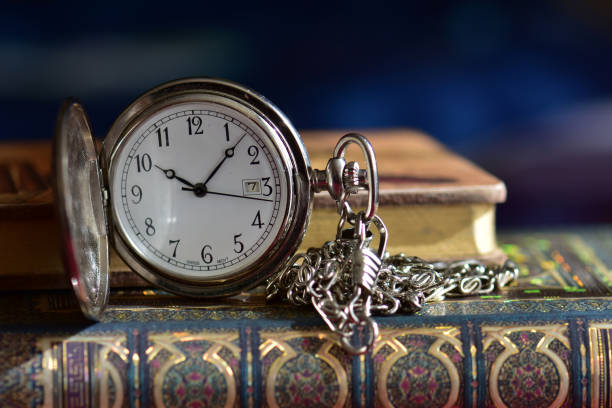 istock Old pocket watch and books 965424576
