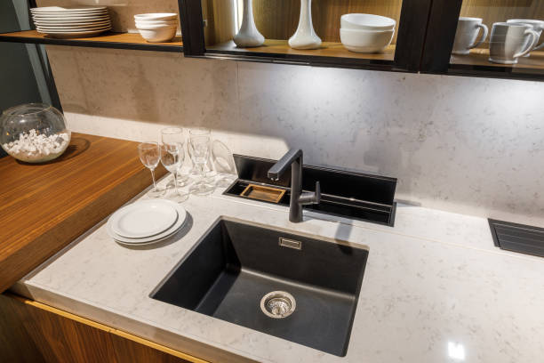 istock Stylish kitchen with tableware and sink on elegant wooden counter 965424768