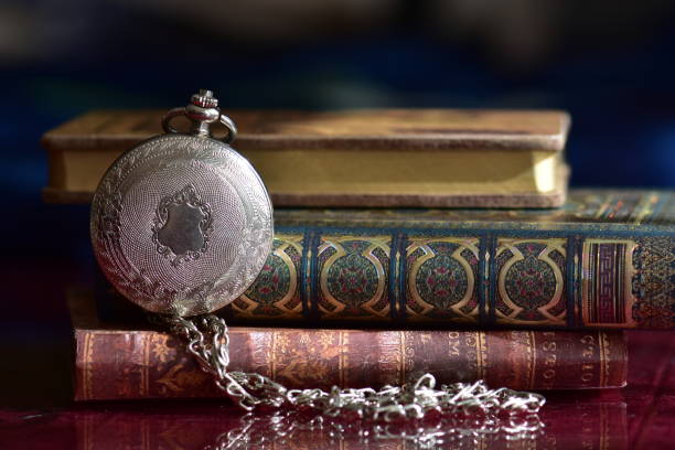 istock Old pocket watch and books 965424800