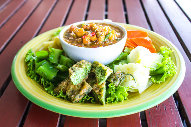 istock Chilli paste with many vegetables, corn, cucumber and fried egg is Thai food. Have a delicious spicy taste. 965424856