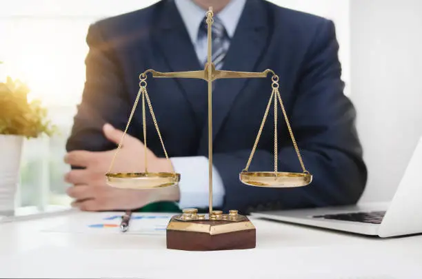Photo of Justice symbol weigh scales on table