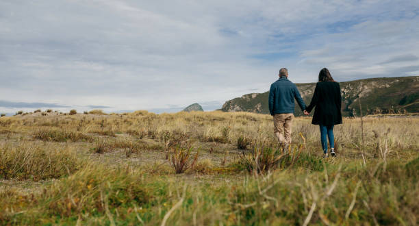 istock Young couple taking a walk near the coast 965425354