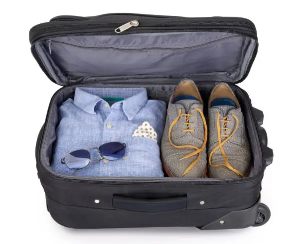 Man's suitcase packed for a short vacation or citytrip
