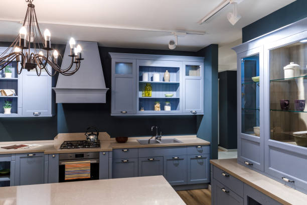 istock Stylish kitchen in blue tones with elegant chandelier 965428412
