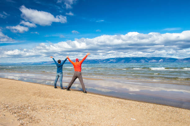 Man and woman holding hands on the seashore