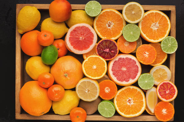 istock Assorted cirtus fruits background, top view 965428694