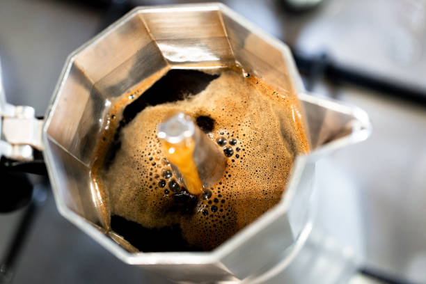 istock Hot fresh made coffee in Italian style mug close up view 965429384
