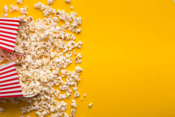 istock Buckets of popcorn on yellow background, top view 965433182
