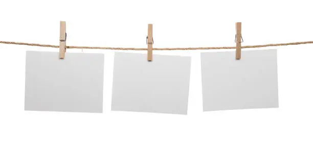 White blank cards with copy space on rope isolated on white background.