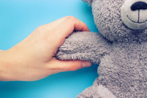 istock girl hands holding a teddy bear 965436264