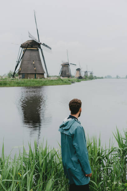istock Man walking near windmills in the Netherlands 965440754