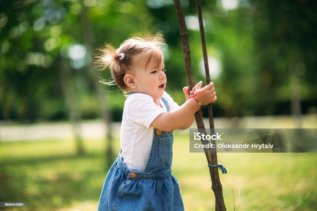 Happy child walks in the park in summer Happy child walks in the park. sunny summer day Adult Stock Photo