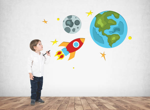 istock Adorable little boy drawing space travel 965444118
