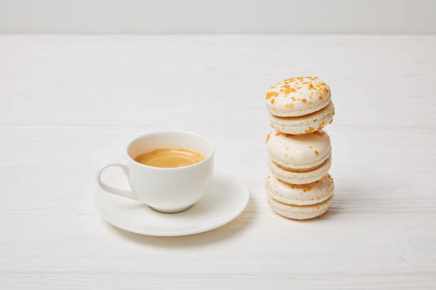 istock closeup shot of coffee cup and stack of macaroons on white wooden table 965444886