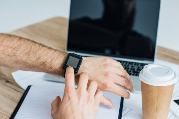 istock close-up partial view of person using smartwatch at workplace 965447640