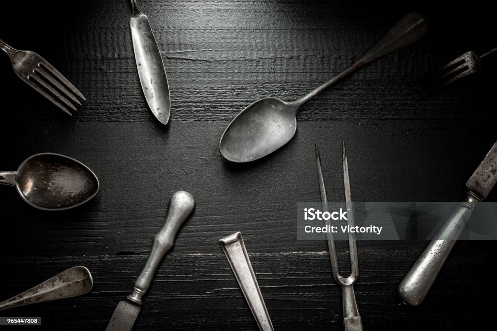 Old Rustic Cutlery on Dark Wooden Background. Kitchen and Food Concept. Antique Stock Photo