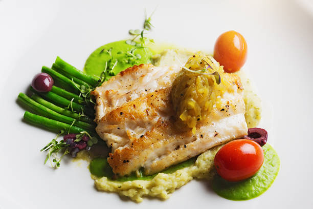 istock Looking down at restaurant dish of grilled fish with accompaniments 965448280
