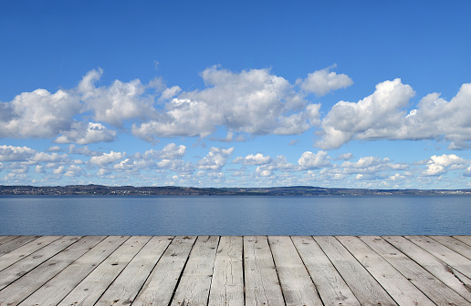 Wooden pier with lake and blue sky
