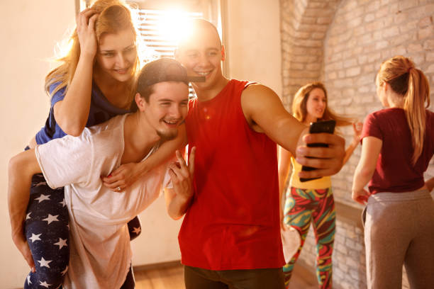 istock Dancers with friends taking funny selfie together 965454924