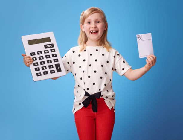 istock smiling child showing prescription and calculator on blue 965455202