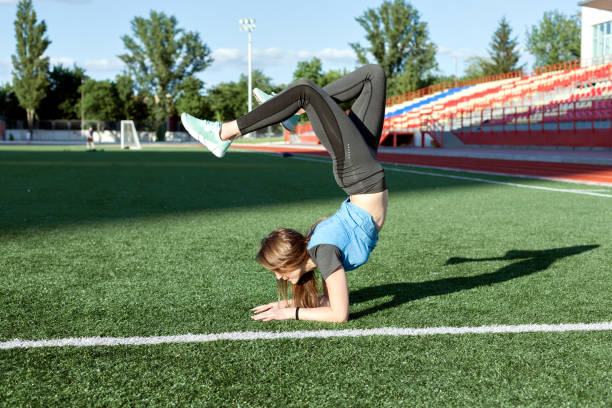 istock Woman is making a stand on her hands. 965455910