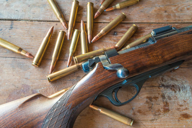 Hunting season concept Hunting gun with bullets on old wooden background ammunition stock pictures, royalty-free photos & images