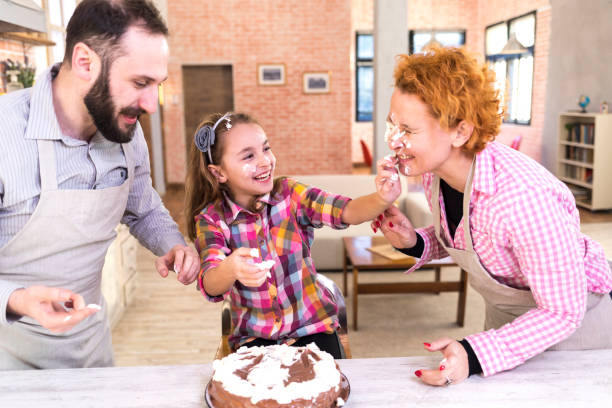 istock Family having fun with birthday cake 965459224