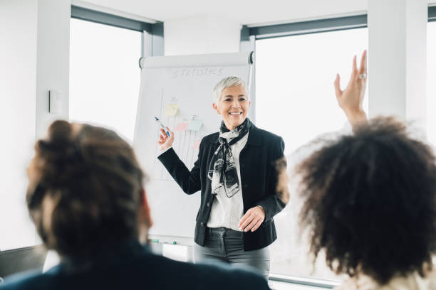 istock Business woman smiling at presentation at work 965459240