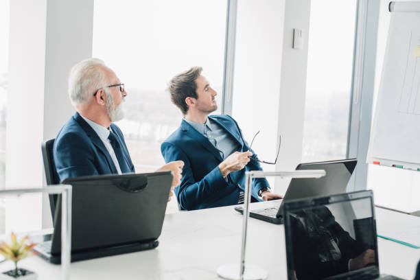 istock Coworkers sitting at board room 965459300