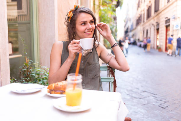 istock Tourist sitting in cafe and drinking coffee 965461440