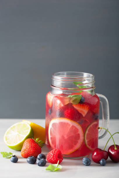 istock summer berry lemonade with lime and mint in mason jar 965461534