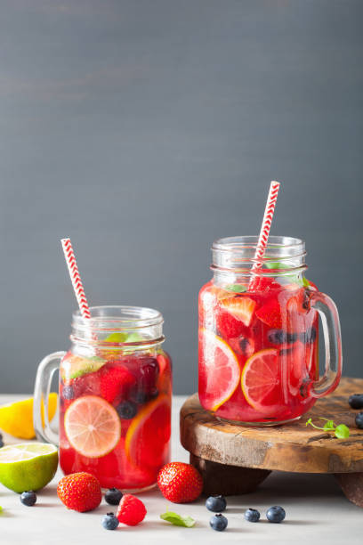 istock summer berry lemonade with lime and mint in mason jar 965461658