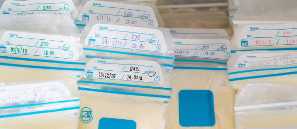 frozen breast milk in plastic bags, freeze mother milk in refrigerator and recording time, quantity and date on milk the bag. frozen breast milk in plastic bags, freeze mother milk in refrigerator and recording time, quantity and date on milk the bag. breast milk stock pictures, royalty-free photos & images