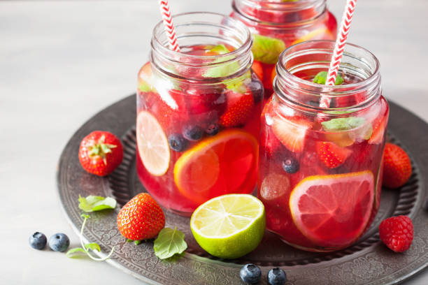 istock summer berry lemonade with lime and mint in mason jar 965462152