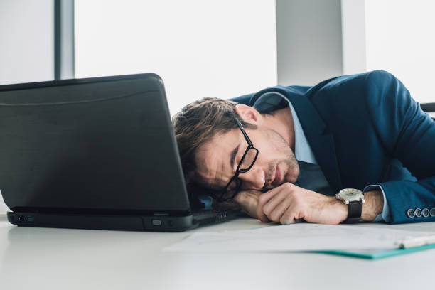 istock Tired young businessman in the office 965462424