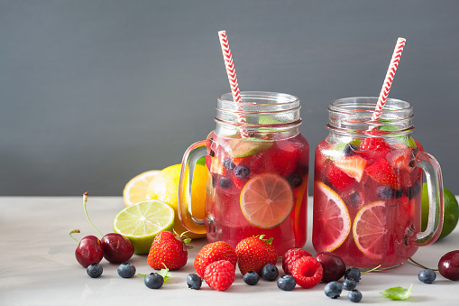 summer berry lemonade with lime and mint in mason jar