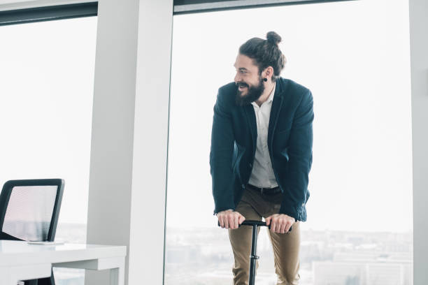 istock Business man with push scooter 965463460