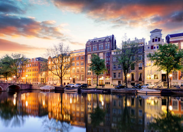 istock Amsterdam Canal houses at sunset reflections, Netherlands 965470544