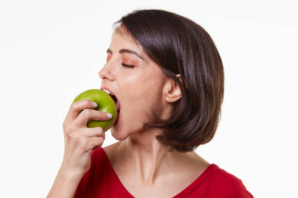 istock cute and beauty young woman and apple 965474252