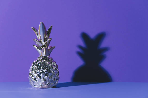 istock Tropical golden Pineapple on ultraviolet background 965474738