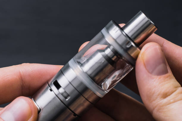 istock Electronic Cigarette. Close-up Of Man Hand Holding 965478474
