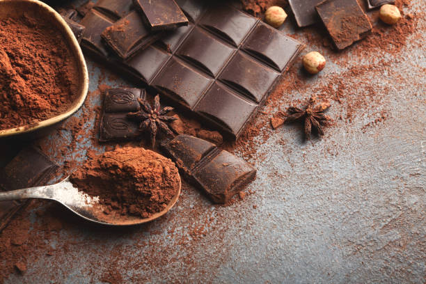 istock Crushed chocolate bar pieces and cocoa on gray background 965480798