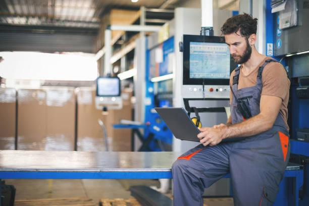 istock Young man setting the machines in factory 965480900