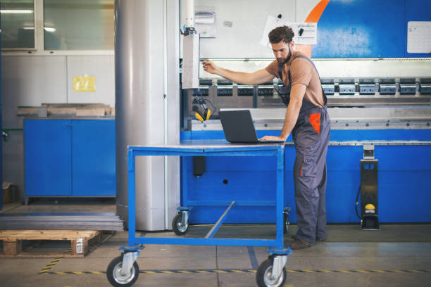 istock Young man setting the machines in factory 965481012