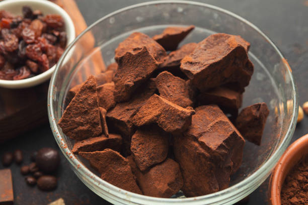istock Crushed chocolate pieces in bowl on black background 965481134