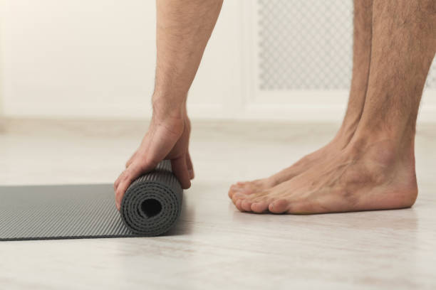 istock Rolling up fitness mat for exercise copy space 965481524