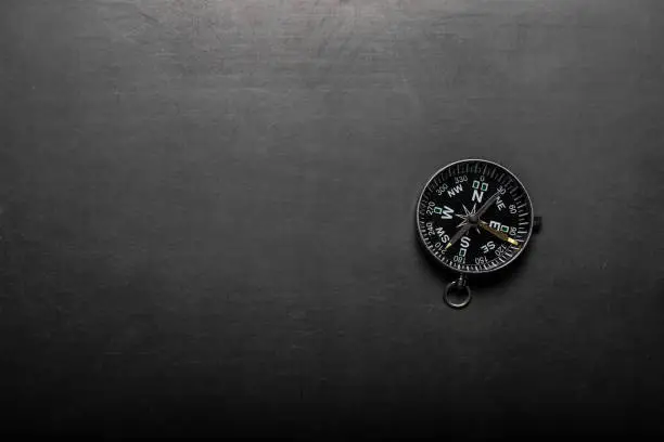 Compass on black board background