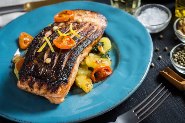 istock Crispy Skin Grilled Salmon with Vegetables on Blue Plate 965492546